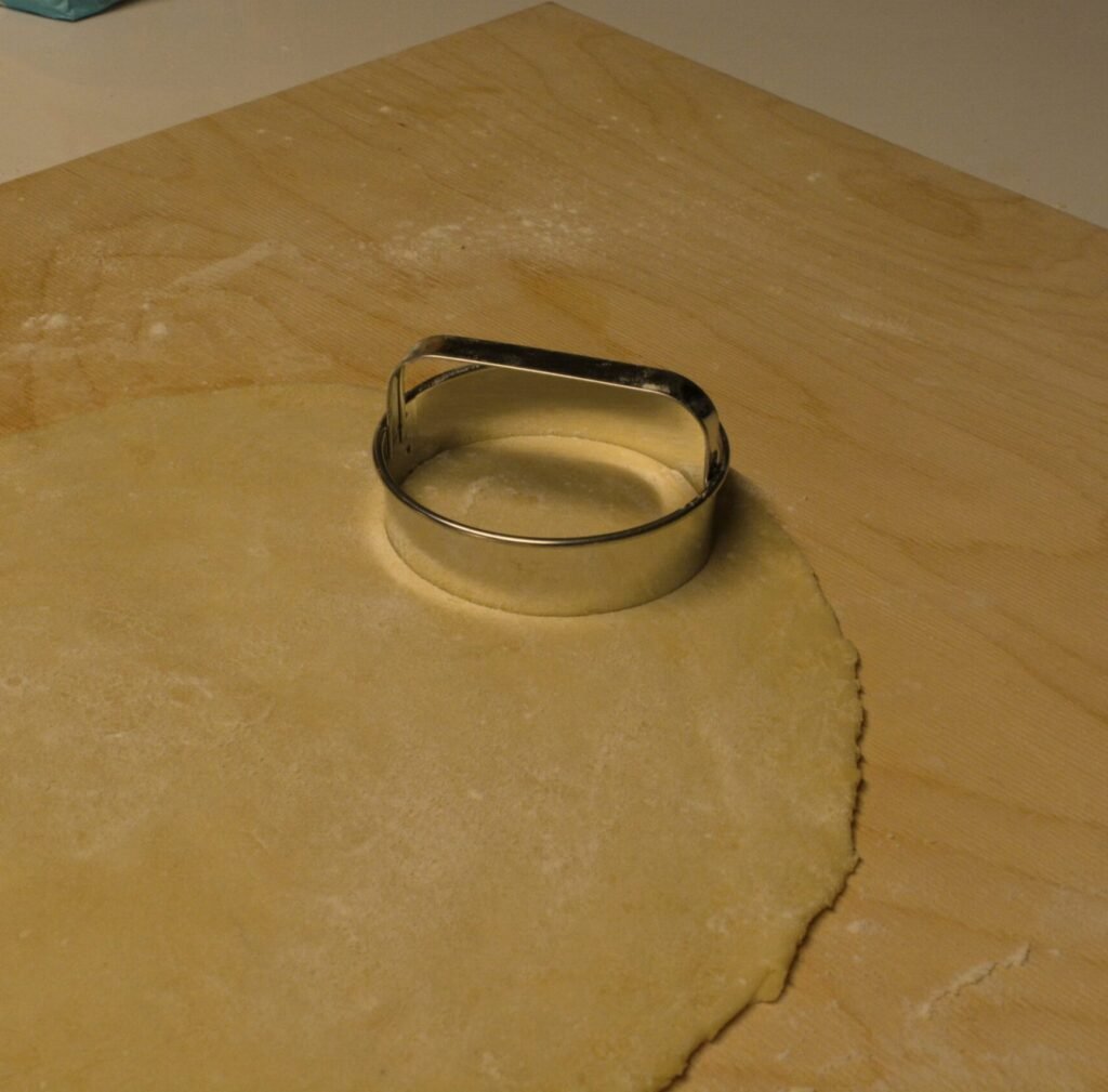 Cutting out circles of dough for pierogi